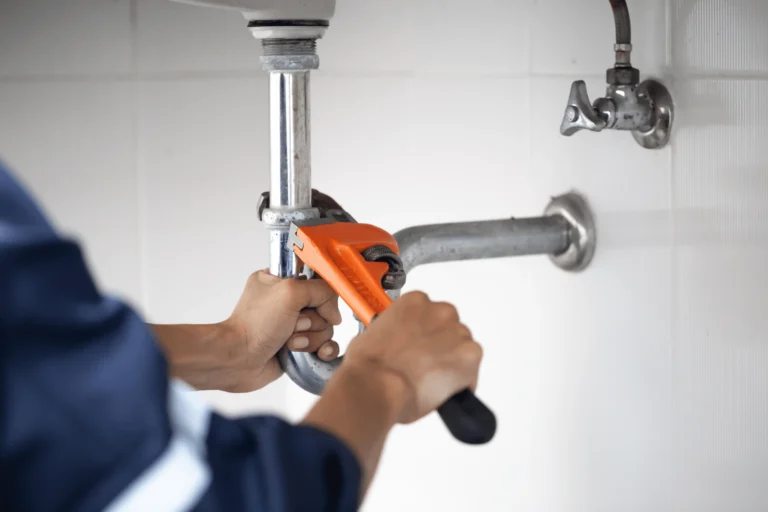 Plumbing problem from water heater being fixed by plumber.